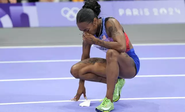 Sha'carri Richardson, of the United States reacts after the women's 100-meters final at the 2024 Summer Olympics, Saturday, Aug. 3, 2024, in Saint-Denis, France. (AP Photo/Matthias Schrader)