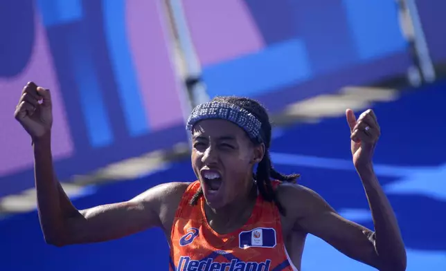 Sifan Hassan, of the Netherlands, celebrates after crossing the finish line to win the gold medal at the end of the women's marathon competition at the 2024 Summer Olympics, Sunday, Aug. 11, 2024, in Paris, France. (AP Photo/Dar Yasin)