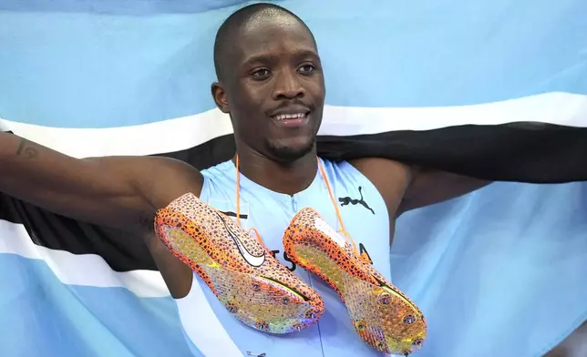 Letsile Tebogo, of Botswana, celebrates after winning the men's 200-meter final at the 2024 Summer Olympics, Thursday, Aug. 8, 2024, in Saint-Denis, France. (AP Photo/Matthias Schrader)