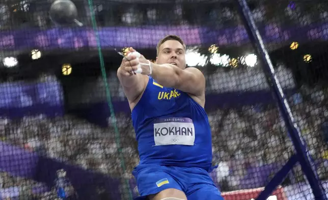 Mykhaylo Kokhan, of Ukraine, competes in the men's hammer throw final at the 2024 Summer Olympics, Sunday, Aug. 4, 2024, in Saint-Denis, France. (AP Photo/Bernat Armangue)