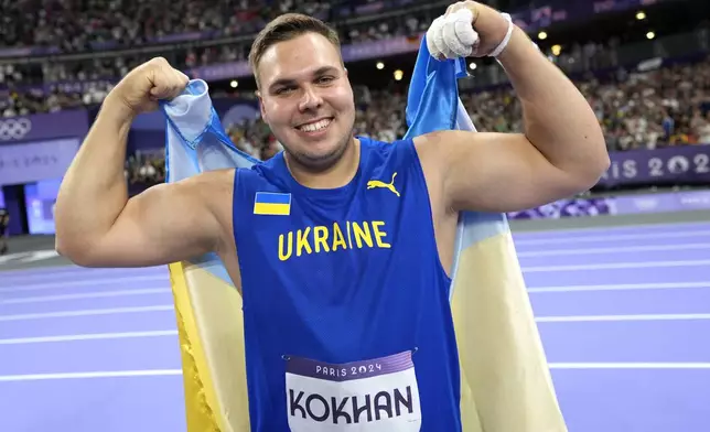 Mykhaylo Kokhan, of Ukraine, reacts after his third place finish in the men's hammer throw final at the 2024 Summer Olympics, Sunday, Aug. 4, 2024, in Saint-Denis, France. (AP Photo/Bernat Armangue)