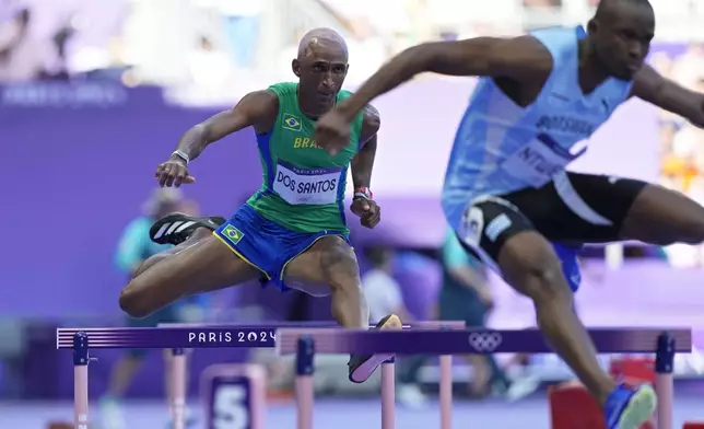 Alison Dos Santos, of Brazil, competes in a men's 400 meters hurdles round 1 heat at the 2024 Summer Olympics, Monday, Aug. 5, 2024, in Saint-Denis, France. (AP Photo/Martin Meissner)