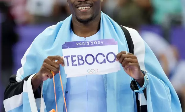 Letsile Tebogo, of Botswana, celebrates after winning the men's 200-meter final at the 2024 Summer Olympics, Thursday, Aug. 8, 2024, in Saint-Denis, France. (AP Photo/Matthias Schrader)