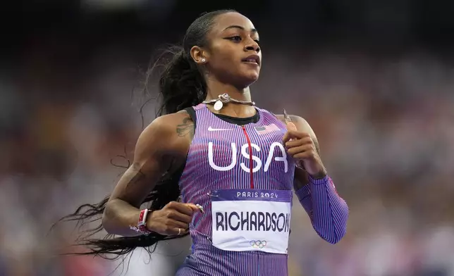 Sha'carri Richardson, of the United States, competes during a women's 100-meter semifinal at the 2024 Summer Olympics, Saturday, Aug. 3, 2024, in Saint-Denis, France. (AP Photo/Petr David Josek)