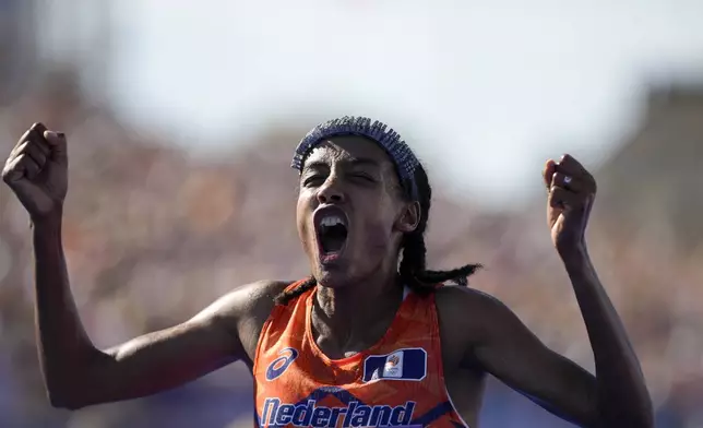 Sifan Hassan, of the Netherlands, celebrates after crossing the finish line to win the gold medal at the end of the women's marathon competition at the 2024 Summer Olympics, Sunday, Aug. 11, 2024, in Paris, France. (AP Photo/Vadim Ghirda)