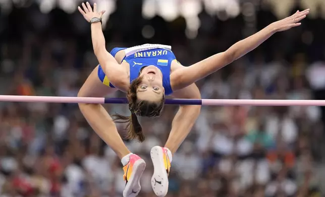 Yaroslava Mahuchikh, of Ukraine, competes in the women's high jump final at the 2024 Summer Olympics, Sunday, Aug. 4, 2024, in Saint-Denis, France. (AP Photo/Matthias Schrader)