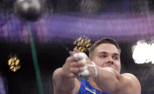 Mykhaylo Kokhan, of Ukraine, competes in the men's hammer throw final at the 2024 Summer Olympics, Sunday, Aug. 4, 2024, in Saint-Denis, France. (AP Photo/Bernat Armangue)