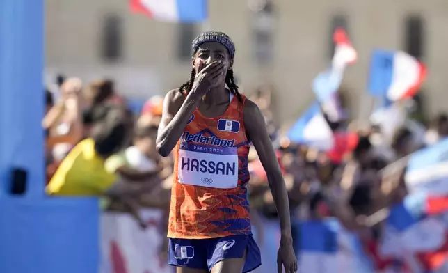 Sifan Hassan, of the Netherlands, celebrates after crossing the finish line to win the gold medal at the end of the women's marathon competition at the 2024 Summer Olympics, Sunday, Aug. 11, 2024, in Paris, France. (AP Photo/Vadim Ghirda)