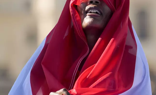 Sifan Hassan, of the Netherlands, celebrates after crossing the finish line to win the gold medal at the end of the women's marathon competition at the 2024 Summer Olympics, Sunday, Aug. 11, 2024, in Paris, France. (AP Photo/Vadim Ghirda)