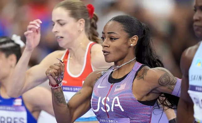 Sha'carri Richardson, of the United States, competes in the women's 100-meter semifinals at the 2024 Summer Olympics, Saturday, Aug. 3, 2024, in Saint-Denis, France. (AP Photo/Matthias Schrader)