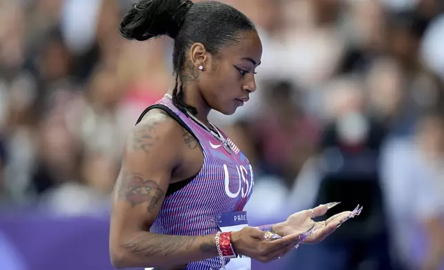 Sha'carri Richardson, of the United States, reacts ahead of her women's 100-meter semifinal at the 2024 Summer Olympics, Saturday, Aug. 3, 2024, in Saint-Denis, France. (AP Photo/Matthias Schrader)