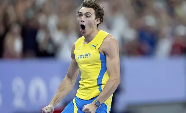 Armand Duplantis, of Sweden, reacts after setting a new world record in the men's pole vault final at the 2024 Summer Olympics, Monday, Aug. 5, 2024, in Saint-Denis, France. (AP Photo/David Goldman)