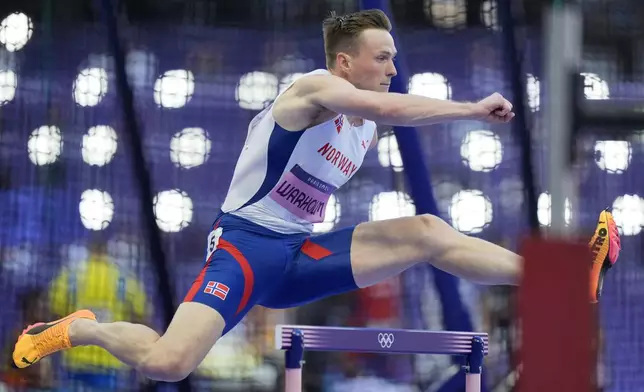 Karsten Warholm, of Norway, competes in a men's 400 meters hurdles round 1 heat at the 2024 Summer Olympics, Monday, Aug. 5, 2024, in Saint-Denis, France. (AP Photo/Martin Meissner)