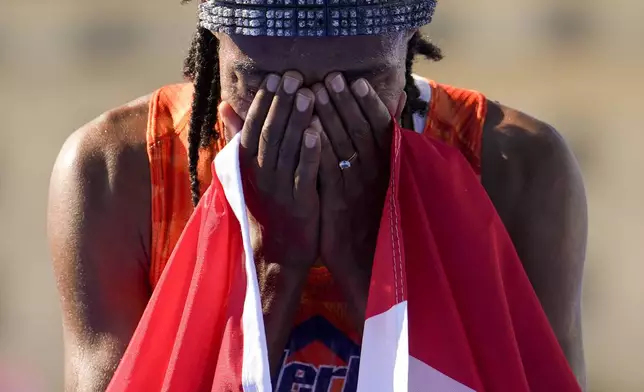 Sifan Hassan, of the Netherlands, reacts after crossing the finish line to win the gold medal at the end of the women's marathon competition at the 2024 Summer Olympics, Sunday, Aug. 11, 2024, in Paris, France. (AP Photo/Vadim Ghirda)