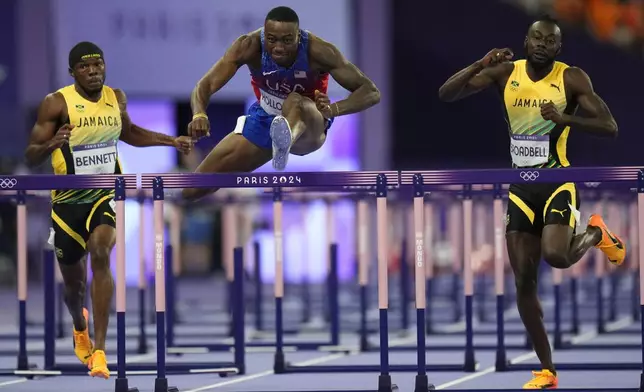 Grant Holloway, of the United States, competes in the men's 110-meters hurdles final at the 2024 Summer Olympics, Thursday, Aug. 8, 2024, in Saint-Denis, France. (AP Photo/Petr David Josek)