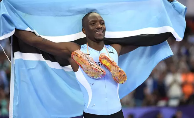 Letsile Tebogo, of Botswana, celebrates after winning the men's 200-meter final at the 2024 Summer Olympics, Thursday, Aug. 8, 2024, in Saint-Denis, France. (AP Photo/Matthias Schrader)