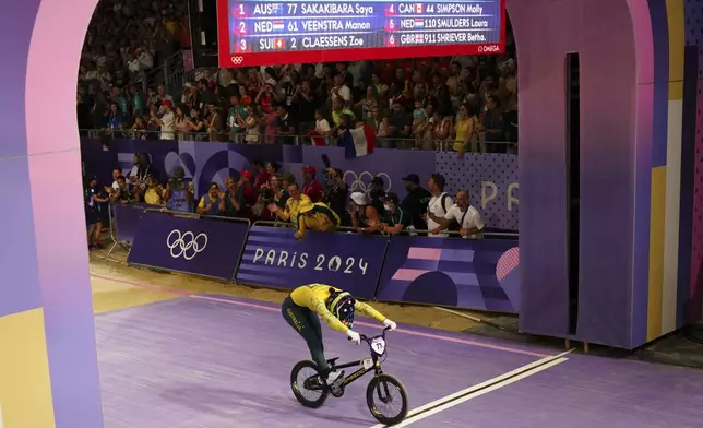 Saya Sakakibara of Australia crosses the finish line to win the gold medal in a BMX racing event, at the 2024 Summer Olympics, Friday, Aug. 2, 2024, in Saint-Quentin-en-Yvelines, France. (AP Photo/Thibault Camus)