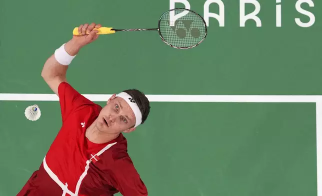 Denmark's Viktor Axelsen plays against Thailand's Kunlavut Vitidsarn during their men's singles badminton gold medal match at the 2024 Summer Olympics, Monday, Aug. 5, 2024, in Paris, France. (Hamad I Mohammed/Pool Photo via AP)