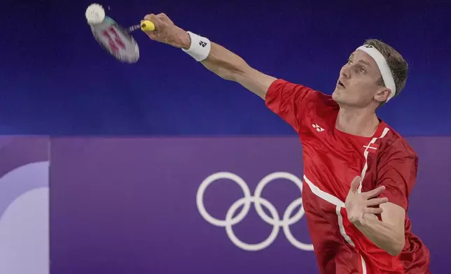 Denmark's Viktor Axelsen plays against Thailand's Kunlavut Vitidsarn during their men's singles badminton gold medal match at the 2024 Summer Olympics, Monday, Aug. 5, 2024, in Paris, France. (AP Photo/Kin Cheung)