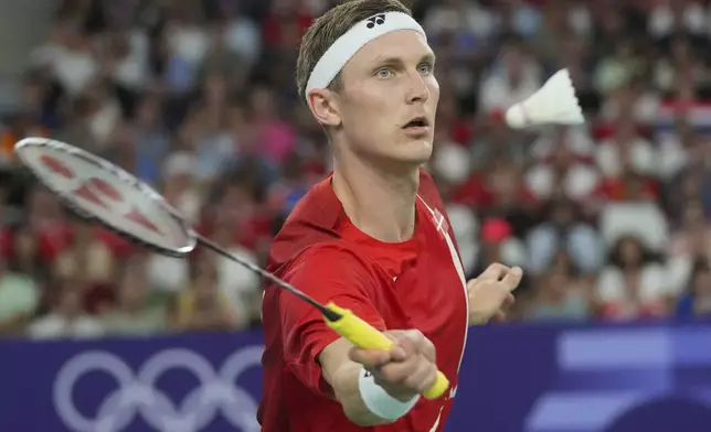 Denmark's Viktor Axelsen plays against Thailand's Kunlavut Vitidsarn during their men's singles badminton gold medal match at the 2024 Summer Olympics, Monday, Aug. 5, 2024, in Paris, France. (AP Photo/Dita Alangkara)