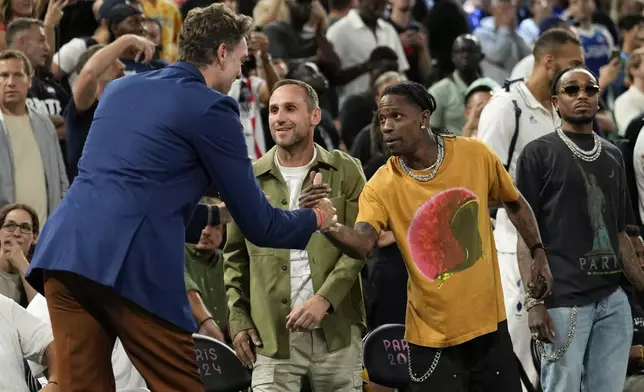 Pau Gasol greets Travis Scott before the USA vs' Serbia game during a men's semifinals basketball game at Bercy Arena at the 2024 Summer Olympics, Thursday, Aug. 8, 2024, in Paris, France. (AP Photo/Mark J. Terrill)