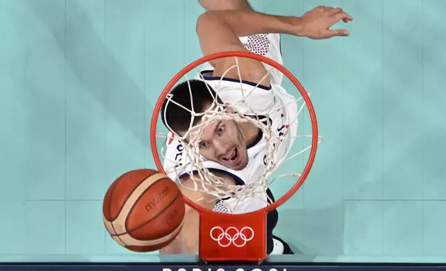 Serbia's Filip Petrusev watches a rebound during a men's basketball game against South Sudan at the 2024 Summer Olympics, Saturday, Aug. 3, 2024, in Villeneuve-d'Ascq, France. (Sameer Al-Doumy/Pool Photo via AP)