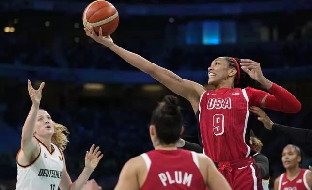 A'ja Wilson (9), of the United States, grabs a rebound over Marie Guelich (11), of Germany, in a women's basketball game at the 2024 Summer Olympics, Sunday, Aug. 4, 2024, in Villeneuve-d'Ascq, France. (AP Photo/Mark J. Terrill)