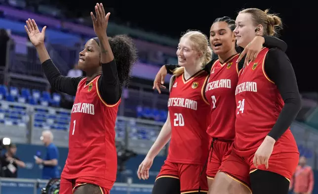 Germany's Alexis Peterson (1) celebrates withe teammates Germany's Frieda Buhner (20), Germany's Satou Sabally (0) and Germany's Lina Sontag after Germany defeated Japan in a women's basketball game at the 2024 Summer Olympics, Thursday, Aug. 1, 2024, in Villeneuve-d'Ascq, France. (AP Photo/Michael Conroy)