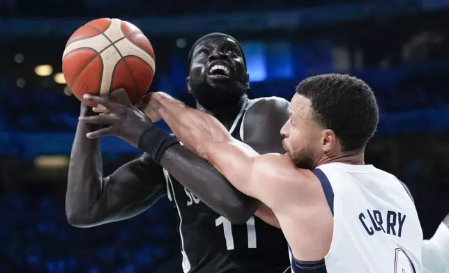 Stephen Curry, of the United States, fools Marial Shayok, of South Sudan, in a men's basketball game at the 2024 Summer Olympics, Wednesday, July 31, 2024, in Villeneuve-d'Ascq, France. (AP Photo/Mark J. Terrill)