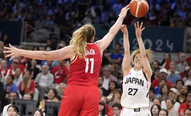 Japan's Saki Hayashi, right, shoots as Germany's Marie Guelich defends during a women's basketball game at the 2024 Summer Olympics, Thursday, Aug. 1, 2024, in Villeneuve-d'Ascq, France. (AP Photo/Michael Conroy)