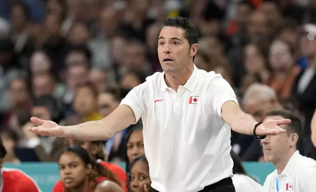 Canada head coach Victor Lapena gestures to his team during a women's basketball game against Australia at the 2024 Summer Olympics, Thursday, Aug. 1, 2024, in Villeneuve-d'Ascq, France. (AP Photo/Michael Conroy)