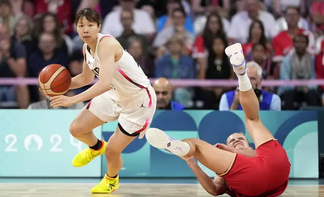 Japan's Nanaka Todo, left, takes the ball as Germany's Leonie Fiebich falls during a women's basketball game at the 2024 Summer Olympics, Thursday, Aug. 1, 2024, in Villeneuve-d'Ascq, France. (AP Photo/Michael Conroy)