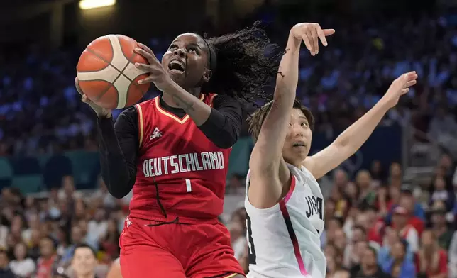 Germany's Alexis Peterson, left, shoots as Japan's Evelyn Mawuli defends during a women's basketball game at the 2024 Summer Olympics, Thursday, Aug. 1, 2024, in Villeneuve-d'Ascq, France. (AP Photo/Michael Conroy)