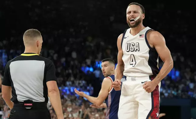 United States' Stephen Curry (4) celebrates a basket in the final minutes against Serbia during a men's semifinals basketball game at Bercy Arena at the 2024 Summer Olympics, Thursday, Aug. 8, 2024, in Paris, France. (AP Photo/Mark J. Terrill)