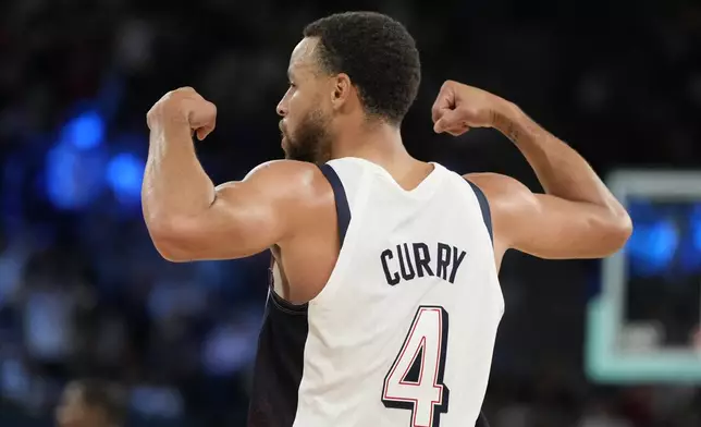 United States' Stephen Curry (4) celebrates against Serbia during a men's semifinals basketball game at Bercy Arena at the 2024 Summer Olympics, Thursday, Aug. 8, 2024, in Paris, France. (AP Photo/Michael Conroy)