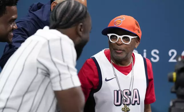 Filemaker Spike Lee is interviewed before a game between the United States and South Sudan in a men's basketball game at the 2024 Summer Olympics, Wednesday, July 31, 2024, in Villeneuve-d'Ascq, France. (AP Photo/Mark J. Terrill)