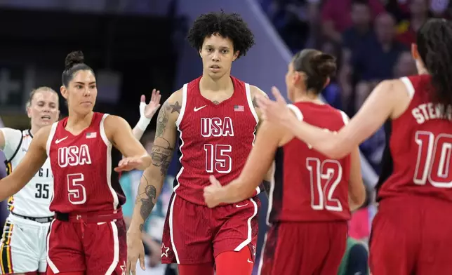 United States' Brittney Griner (15) is surrounded by teammates, United States' Kelsey Plum (5), United States' Diana Taurasi, (12) and United States' Breanna Stewart (10) after being fouled during a women's basketball game against Belgium at the 2024 Summer Olympics, Thursday, Aug. 1, 2024, in Villeneuve-d'Ascq, France. (AP Photo/Michael Conroy)