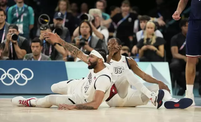 United States' Kevin Durant, right, draws the foul after scoring as United States' Anthony Davis (14) reacts against Serbia during a men's semifinals basketball game at Bercy Arena at the 2024 Summer Olympics, Thursday, Aug. 8, 2024, in Paris, France. (AP Photo/Mark J. Terrill)