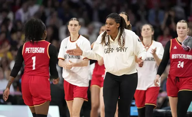 Germany's Nyara Sabally, center, congratulates Germany's Alexis Peterson during a timeout during a women's basketball game at the 2024 Summer Olympics, Thursday, Aug. 1, 2024, in Villeneuve-d'Ascq, France. (AP Photo/Michael Conroy)