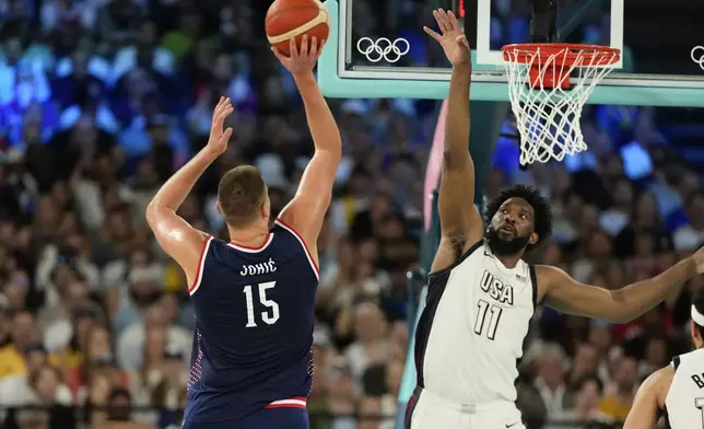 Nikola Jokic (15), of Serbia shoots over United States' Joel Embiid (11) during a men's semifinals basketball game at Bercy Arena at the 2024 Summer Olympics, Thursday, Aug. 8, 2024, in Paris, France. (AP Photo/Mark J. Terrill)