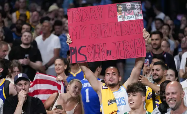 United States fans cheer before the start a men's basketball gamebetween the United States South Sudan at the 2024 Summer Olympics, Wednesday, July 31, 2024, in Villeneuve-d'Ascq, France. (AP Photo/Mark J. Terrill)