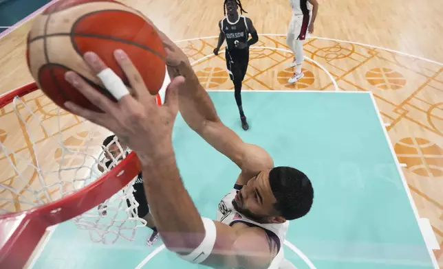 Jayson Tatum, of the United States, gets a basket on a dunk against South Sudan in a men's basketball game at the 2024 Summer Olympics, Wednesday, July 31, 2024, in Villeneuve-d'Ascq, France. (AP Photo/Mark J. Terrill, Pool)