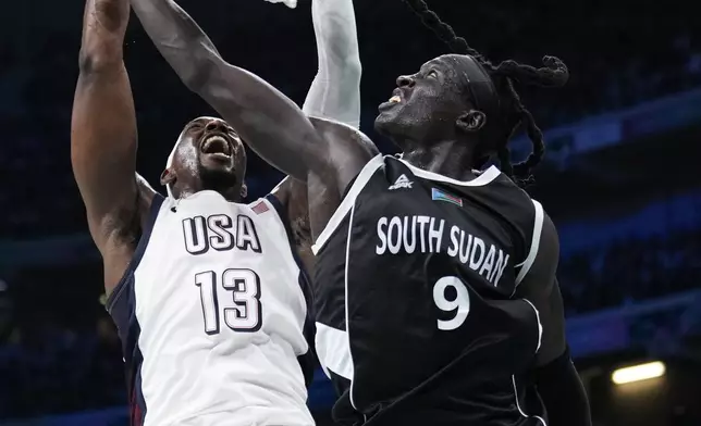 Bam Adebayo, of the United States, get a basket over Wenyen Gabriel, of South Sudan, in a men's basketball game at the 2024 Summer Olympics, Wednesday, July 31, 2024, in Villeneuve-d'Ascq, France. (AP Photo/Mark J. Terrill)