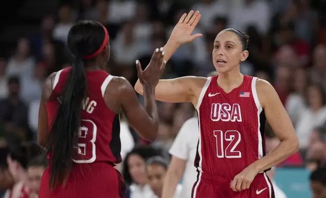 United States' Diana Taurasi (12) celebrates with United States' Jackie Young (13) during a women's quarterfinal game against Nigeria at Bercy Arena at the 2024 Summer Olympics, Wednesday, Aug. 7, 2024, in Paris, France. (AP Photo/Mark J. Terrill)