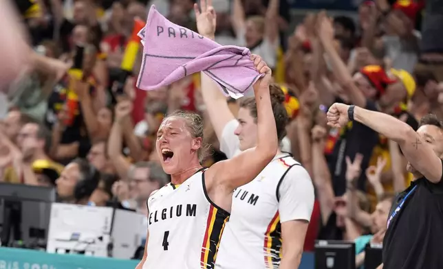 Belgium's Elisa Ramette celebrates from the bench after the scored during a women's basketball game against the United States at the 2024 Summer Olympics, Thursday, Aug. 1, 2024, in Villeneuve-d'Ascq, France. (AP Photo/Michael Conroy)