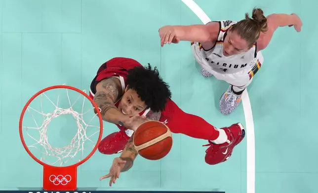 United States' Brittney Griner, left, shoots as Belgium's Emma Meesseman defends in a women's basketball game at the 2024 Summer Olympics, Thursday, Aug. 1, 2024, in Villeneuve-d'Ascq, France. (Evelyn Hockstein/Pool Photo via AP)