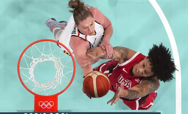 United States' Brittney Griner, right, and Belgium's Emma Meesseman reach for a rebound in a women's basketball game at the 2024 Summer Olympics, Thursday, Aug. 1, 2024, in Villeneuve-d'Ascq, France. (Evelyn Hockstein/Pool Photo via AP)