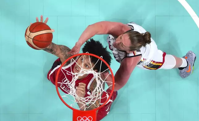 United States' Brittney Griner, left, and Belgium's Emma Meesseman reach for a rebound in a women's basketball game at the 2024 Summer Olympics, Thursday, Aug. 1, 2024, in Villeneuve-d'Ascq, France. (Evelyn Hockstein/Pool Photo via AP)