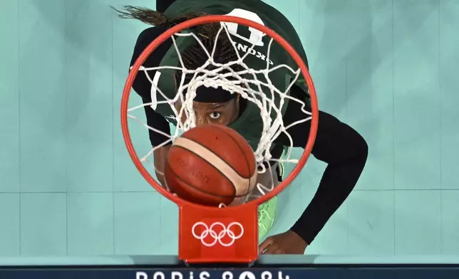 Nigeria's Amy Okonkwo watches the ball go in during a women's basketball game against France at the 2024 Summer Olympics, Thursday, Aug. 1, 2024, in Villeneuve-d'Ascq, France. (Sameer Al-Doumy/Pool Photo via AP)