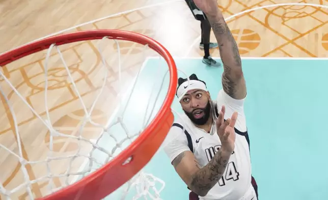 Anthony Davis, of the United States, shoots over Carlik Jones, of South Sudan, in a men's basketball game at the 2024 Summer Olympics, Wednesday, July 31, 2024, in Villeneuve-d'Ascq, France. (AP Photo/Mark J. Terrill, Pool)